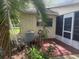 Home exterior featuring screened lanai, landscaped yard, and mature trees at 9722 Sw 95Th Ct # C, Ocala, FL 34481