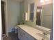 Bright bathroom with a large mirror and well-lit vanity, complemented by a neutral color scheme at 9722 Sw 95Th Ct # C, Ocala, FL 34481