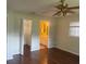 Bedroom with hardwood floors, a ceiling fan, and access to a walk-in closet and attached bathroom at 9722 Sw 95Th Ct # C, Ocala, FL 34481