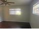 Bright bedroom with dark hardwood floors and dual windows at 9722 Sw 95Th Ct # C, Ocala, FL 34481
