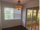Bright breakfast nook features a chandelier and a sliding glass door to a patio at 9722 Sw 95Th Ct # C, Ocala, FL 34481