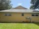 Home exterior featuring visible utilities, windows, and a gable roof at 9722 Sw 95Th Ct # C, Ocala, FL 34481