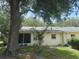 View of a house featuring large tree, lanai, and surrounding vegetation at 9722 Sw 95Th Ct # C, Ocala, FL 34481