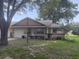 Charming single-story home with an attached garage, manicured lawn, and a cozy front porch at 9722 Sw 95Th Ct # C, Ocala, FL 34481