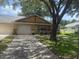 Charming single story home featuring an attached garage, manicured lawn, and mature trees at 9722 Sw 95Th Ct # C, Ocala, FL 34481