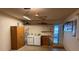 Laundry area with washer, dryer, shelving, and water heater at 9722 Sw 95Th Ct # C, Ocala, FL 34481
