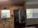 Spacious kitchen with stainless steel refrigerator, granite counters, and window at 9722 Sw 95Th Ct # C, Ocala, FL 34481
