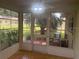The screened lanai has tile flooring and views of the surrounding landscaping at 9722 Sw 95Th Ct # C, Ocala, FL 34481