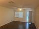 Living room boasts a large window, rear door, and neutral color palette at 9722 Sw 95Th Ct # C, Ocala, FL 34481