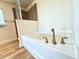 Bathroom featuring an enclosed bathtub and faucet fixtures at 10405 Sw 47Th Ave, Ocala, Florida, FL 34476