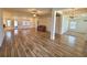 Open-concept living room with tile floors, ceiling fan, and a view of dining and kitchen areas at 10405 Sw 47Th Ave, Ocala, Florida, FL 34476