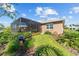 Backyard featuring a screened lanai, verdant landscaping, and a cozy pathway leading to the house at 10584 Sw 91St Street Rd, Ocala, FL 34481