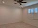 Empty room with tile floor features a ceiling fan and plantation shutters on window at 10584 Sw 91St Street Rd, Ocala, FL 34481