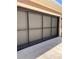 View of the house garage door with a retractable screen system installed to create a bug-free space at 10584 Sw 91St Street Rd, Ocala, FL 34481