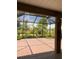 Relaxing outdoor space boasting a screened-in lanai with a view of lush greenery and blue skies at 10584 Sw 91St Street Rd, Ocala, FL 34481