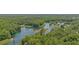 Breathtaking aerial view of a river winding through a lush, green landscape, showcasing the natural beauty of the area at 12178 Palmetto Way, Dunnellon, FL 34432