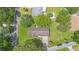 Overhead view of the home with a well-manicured lawn, mature trees, and proximity to neighborhood pool at 12178 Palmetto Way, Dunnellon, FL 34432