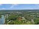 An aerial view of a charming single-story home surrounded by lush trees in a serene, picturesque setting at 12178 Palmetto Way, Dunnellon, FL 34432