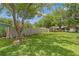 Spacious back yard with lush grass, mature tree, privacy fence, and plenty of room for outdoor activities at 12178 Palmetto Way, Dunnellon, FL 34432