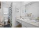 Bright bathroom featuring a single sink vanity, toilet, and shower with decorative curtain at 12178 Palmetto Way, Dunnellon, FL 34432