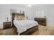 Bedroom featuring natural light, wood-look floors, a ceiling fan, and rustic furniture at 12178 Palmetto Way, Dunnellon, FL 34432