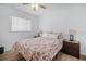 Bedroom features wood-look floors, a ceiling fan, and a window for natural light at 12178 Palmetto Way, Dunnellon, FL 34432