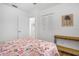 Bright bedroom with wood-look floors, a ceiling fan, and a double closet at 12178 Palmetto Way, Dunnellon, FL 34432