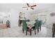 Dining room featuring seating for six, ceiling fan, and sliding glass door at 12178 Palmetto Way, Dunnellon, FL 34432