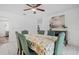 Dining room with seating for six, ceiling fan, and bright natural light at 12178 Palmetto Way, Dunnellon, FL 34432