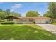 Charming single-story home featuring a well-maintained lawn and attached two-car garage at 12178 Palmetto Way, Dunnellon, FL 34432