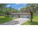 One-story home with 2 car garage and a long driveway at 12178 Palmetto Way, Dunnellon, FL 34432