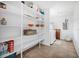 Bright laundry room featuring ample shelving for storage and side-by-side washer and dryer at 12178 Palmetto Way, Dunnellon, FL 34432
