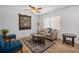 Cozy living room with bright sunlight, new wood-look floors, comfortable seating, and inviting décor at 12178 Palmetto Way, Dunnellon, FL 34432
