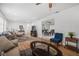 Spacious living room with new floors, comfortable seating, and open layout to the dining area at 12178 Palmetto Way, Dunnellon, FL 34432