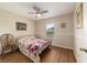 Cozy bedroom featuring wood floors, ceiling fan, and a bright window for natural light at 1245 Nw 67Th Pl, Ocala, FL 34475