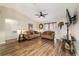 Comfortable living room featuring wood floors, ceiling fan, and ample seating at 1245 Nw 67Th Pl, Ocala, FL 34475