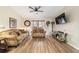 Comfortable living room featuring wood floors, ceiling fan, and ample seating at 1245 Nw 67Th Pl, Ocala, FL 34475