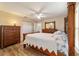 Cozy bedroom with wood floors, ceiling fan, and a matching wood furniture set at 1245 Nw 67Th Pl, Ocala, FL 34475