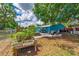 Serene backyard with a garden, patio, deck, and above ground swimming pool at 1404 Richmond Rd, Lakeland, FL 33801