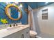 This updated bathroom offers a vanity with storage, and a shower with white subway tiles at 1404 Richmond Rd, Lakeland, FL 33801