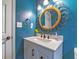 This stylish bathroom features a vanity with storage, and a decorative mirror at 1404 Richmond Rd, Lakeland, FL 33801