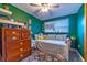 This cozy bedroom offers a floral day bed, a ceiling fan and neutral colors at 1404 Richmond Rd, Lakeland, FL 33801