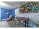 Comfortable bedroom featuring blue walls, light-colored flooring, and a work table at 1404 Richmond Rd, Lakeland, FL 33801