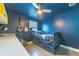 This charming bedroom features a bed with storage drawers and guitars hanging on the wall at 1404 Richmond Rd, Lakeland, FL 33801