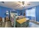 Comfortable bedroom featuring blue walls, light-colored flooring, and a ceiling fan at 1404 Richmond Rd, Lakeland, FL 33801