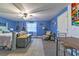 Comfortable bedroom featuring blue walls, light-colored flooring, a ceiling fan, and a work table at 1404 Richmond Rd, Lakeland, FL 33801