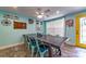 Bright dining room with a ceiling fan, large window, and a long dining table with seating for six at 1404 Richmond Rd, Lakeland, FL 33801