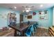 Bright dining room featuring a large dining table with space for eight, tile floors, and playful decorations at 1404 Richmond Rd, Lakeland, FL 33801