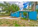 Charming blue single-story home with well-manicured landscaping and inviting curb appeal at 1404 Richmond Rd, Lakeland, FL 33801
