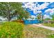 Colorful home exterior with lush greenery, a driveway, and a charming neighborhood setting at 1404 Richmond Rd, Lakeland, FL 33801